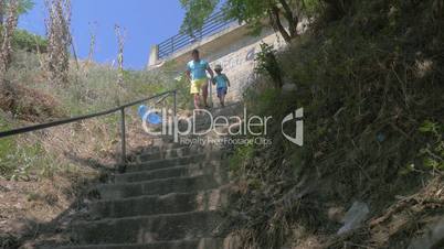 In city Perea, Greece in park down the stairs father with his son