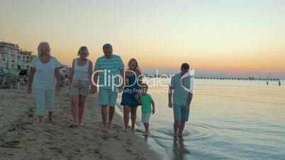 Big happy funny family walks on the beach on sea sunset background Piraeus, Greece