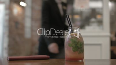 Refreshing cocktail with citrus on cafe table