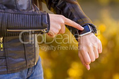 Teenager girl using touchscreen smart watch