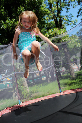 girl jumps on the trampoline