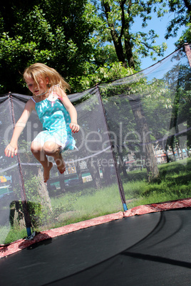 girl jumps on the trampoline