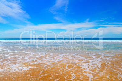 ocean, sandy beach and blue sky