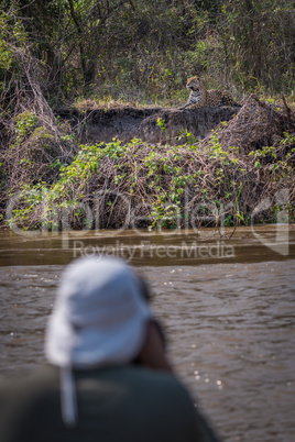 Jaguar being shot by photographer in foreground