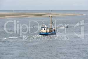 Fishing boat on the Wadden Sea .