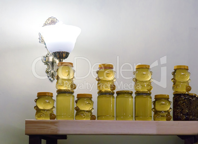 Different varieties of honey in banks, offered for sale