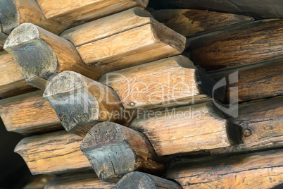 Fragment of the wall executed from processed natural round logs.