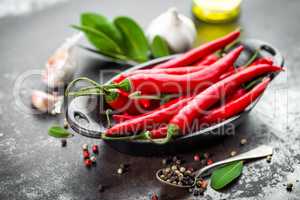 red hot chili pepper corns and pods on dark old metal culinary background