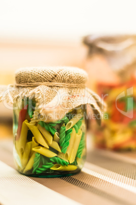 Colored pasta in glass jar