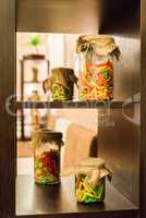Colored pasta in glass jars