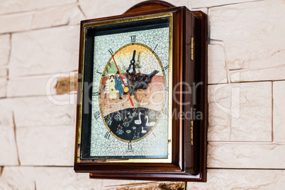 clock hanging on stone wall