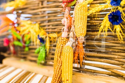 Corn decoration hanging on fence