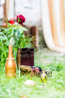 Red Rose in gilded bottle