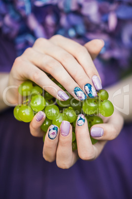 Hands with Nails Holding Grapes