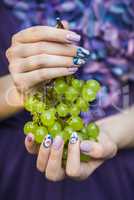 Hands with Nails Holding Grapes