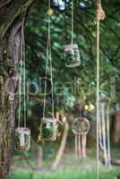 Glass jars hanging on tree