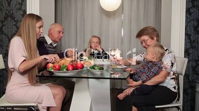 Happy family eating traditional Thanksgiving food