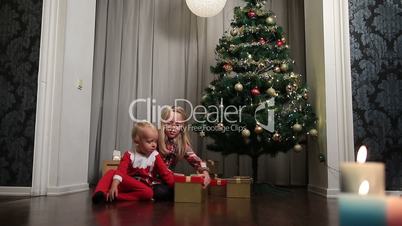 Happy children opening Christmas gift boxes