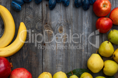 Ripe fruit on wooden background