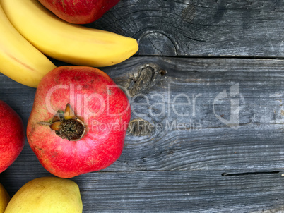 Red pomegranate on a black wooden background
