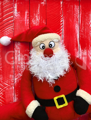 Happy Santa Claus on a red wooden background