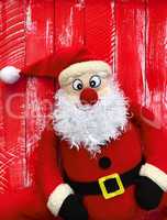 Happy Santa Claus on a red wooden background