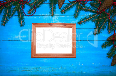 Wooden photo frame on a blue wooden background