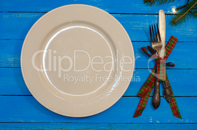 White plate, knife and fork in a festive serving for the holiday
