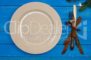 White plate, knife and fork in a festive serving for the holiday