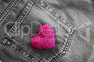red knitted heart in the back pocket of jeans