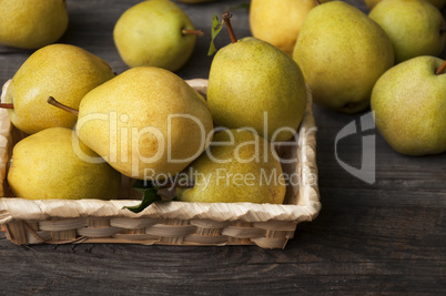 Fresh ripe yellow pears in a wicker basket