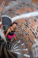 the girl in the pink shorts up the narrow stone stairs