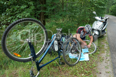 man repairing a Bicycle during the journey, puncture Bicycle tires wheels during skating
