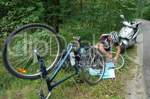 man repairing a Bicycle during the journey, puncture Bicycle tires wheels during skating