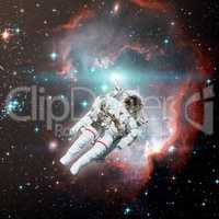 Astronaut in outer space. Nebula on the background.