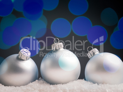 Old used Christmas baubles in snow