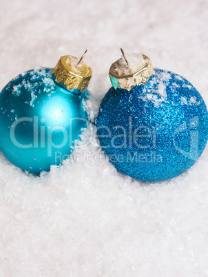 Blue Christmas baubles on snow