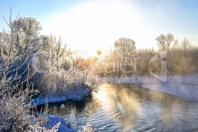 Winter sunny landscape with river and forest