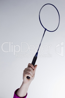 Female hand with a badminton racket