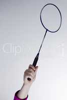 Female hand with a badminton racket