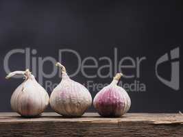 Three fresh garlic on wood