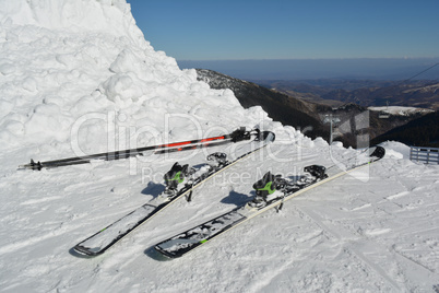 Skis and ski poles in the snow