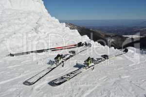 Skis and ski poles in the snow