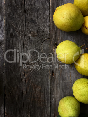 Ripe pear on a gray wooden surface, empty space