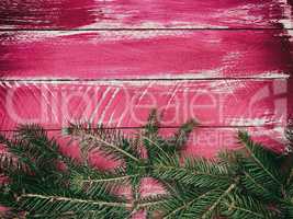 Vintage wooden pink background with branches of spruce, empty sp
