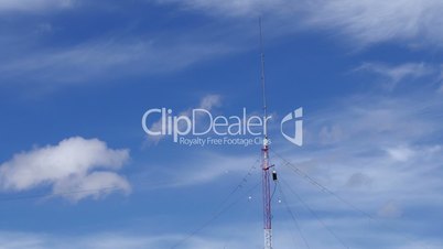 Home based single spike Telecommunications antenna tower light clouds day time lapse