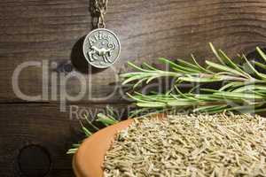 Fresh rosemary and a bowl with dried