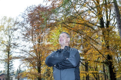 Man stands in the autumn wood