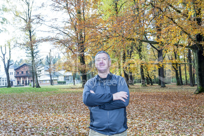 Man stands in the autumn wood