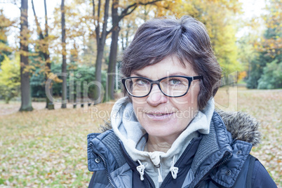 Woman enjoys the autumn wood